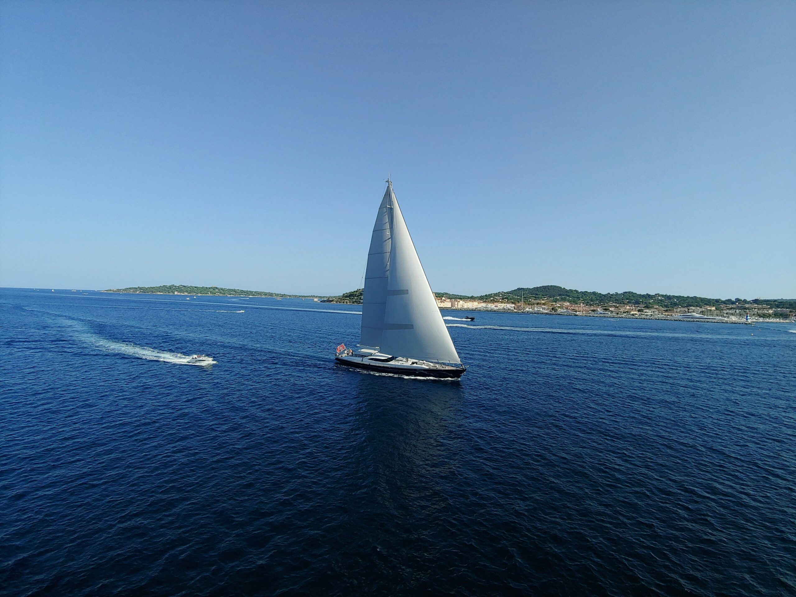 black sail boat on sea