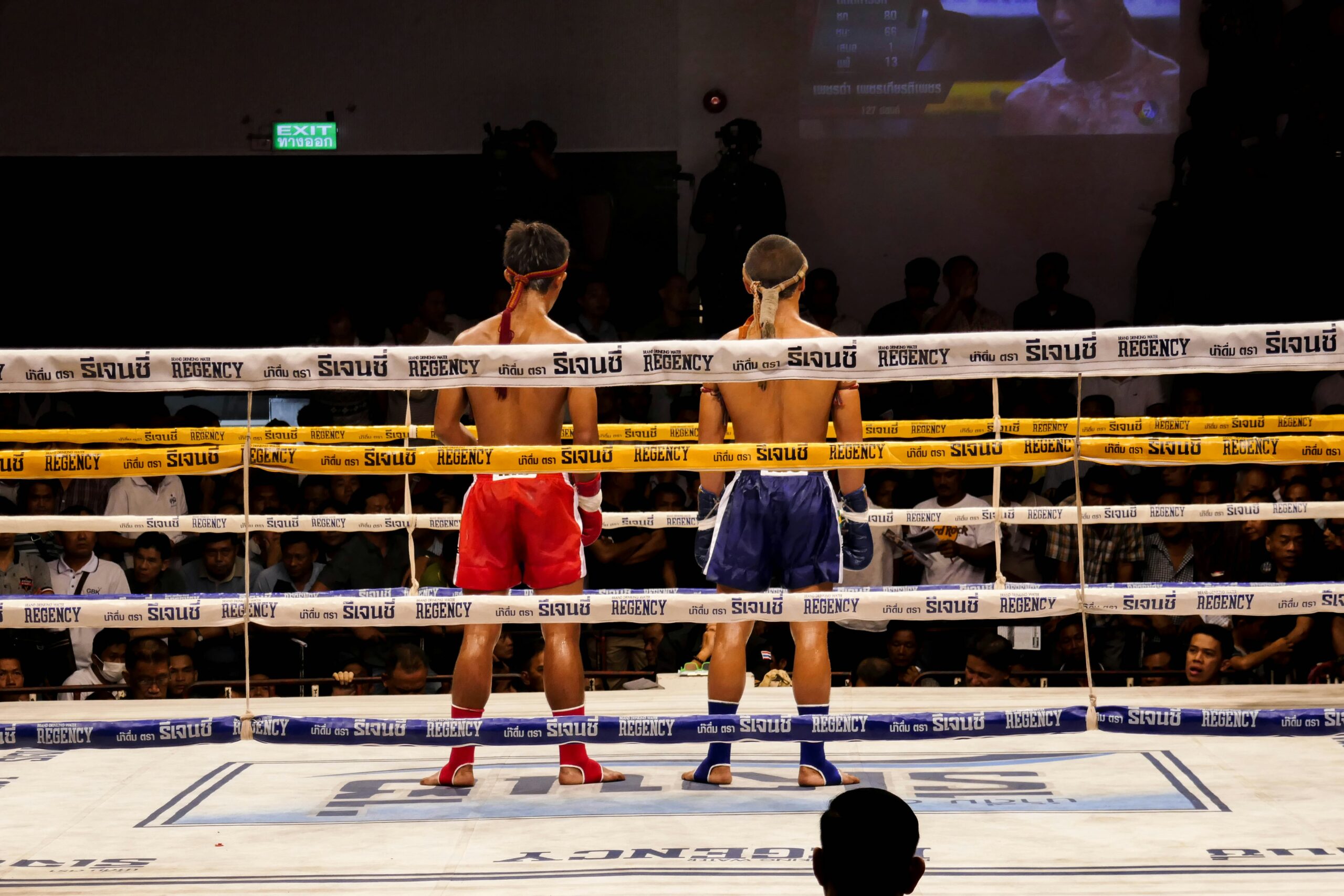 man in blue shorts standing beside man in black shorts