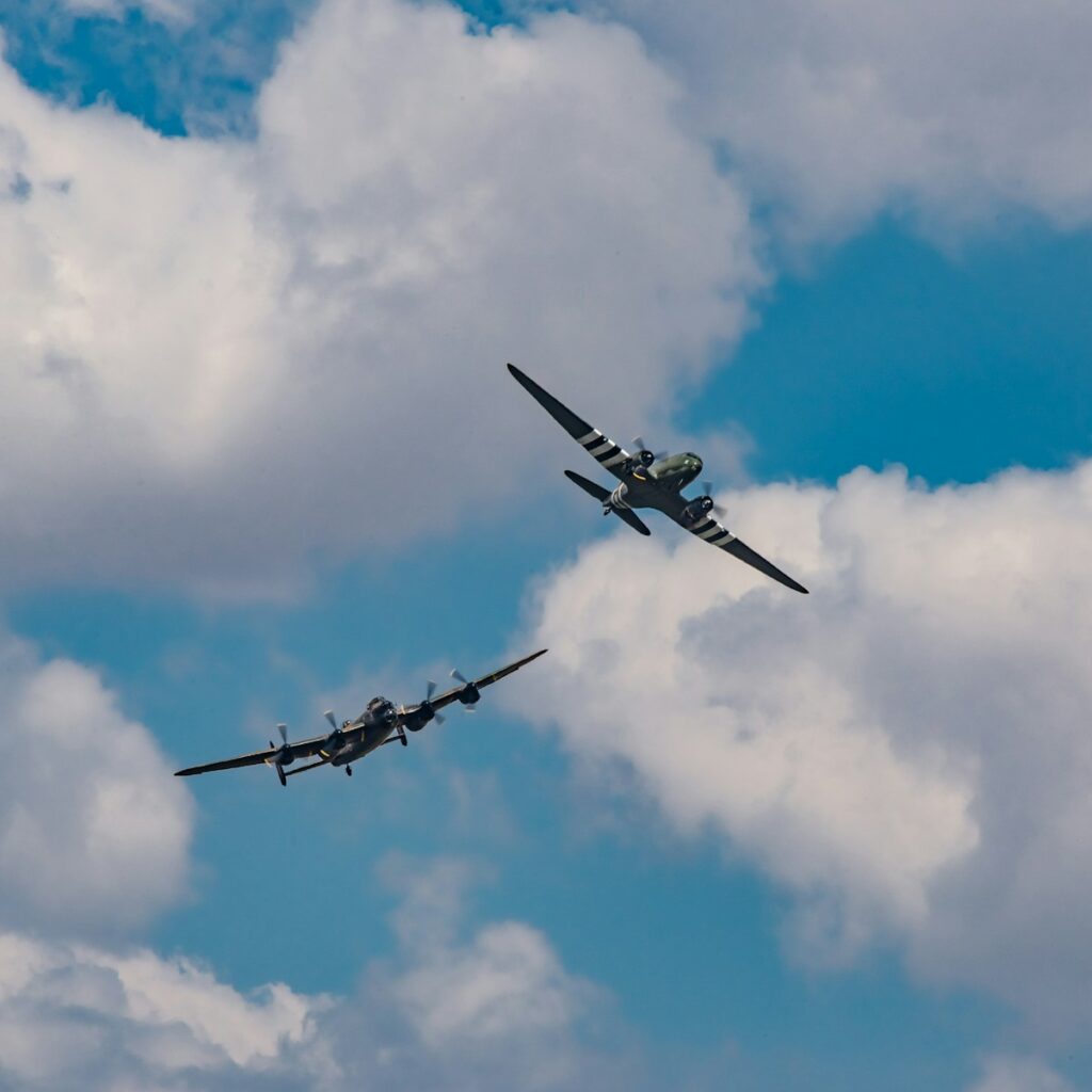 two planes under white clouds during daytime Sky Force